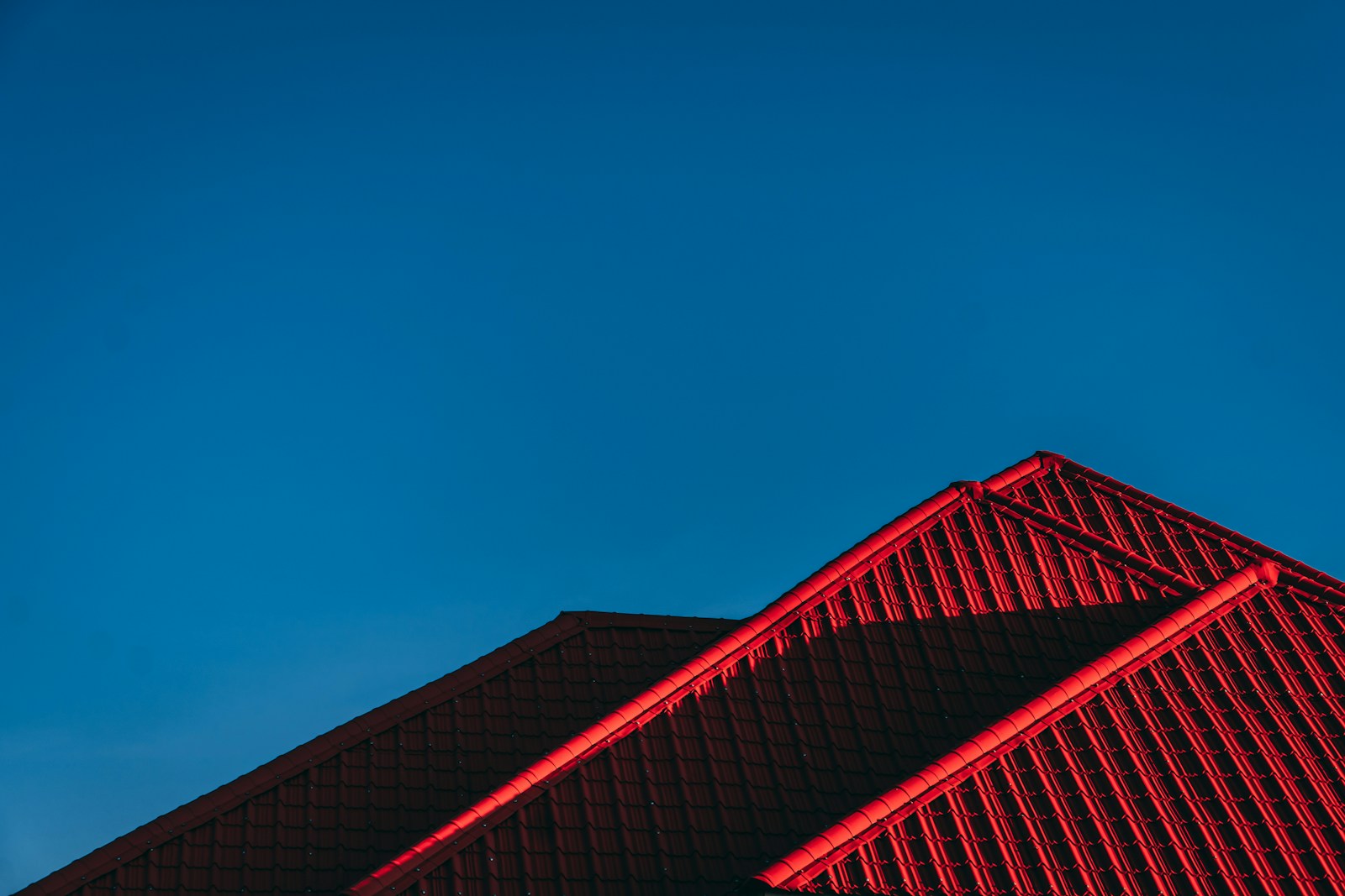 red and black building under blue sky remodeled using homeowners insurance roof coverage